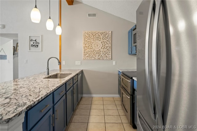 kitchen with appliances with stainless steel finishes, blue cabinetry, sink, and pendant lighting