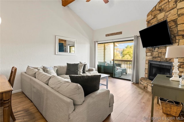 living room with vaulted ceiling with beams, wood-type flooring, a fireplace, and ceiling fan