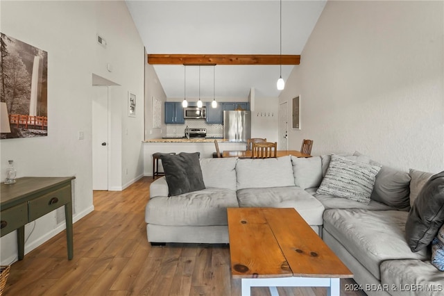 living room with beam ceiling, high vaulted ceiling, and wood-type flooring