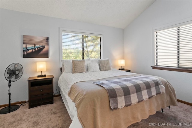 bedroom with multiple windows, light colored carpet, and lofted ceiling