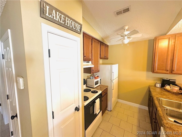 kitchen with lofted ceiling, sink, a textured ceiling, white appliances, and ceiling fan