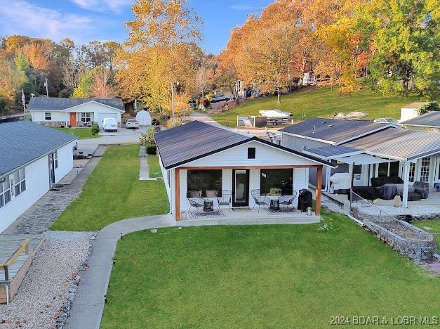 back of house featuring a yard and a patio area