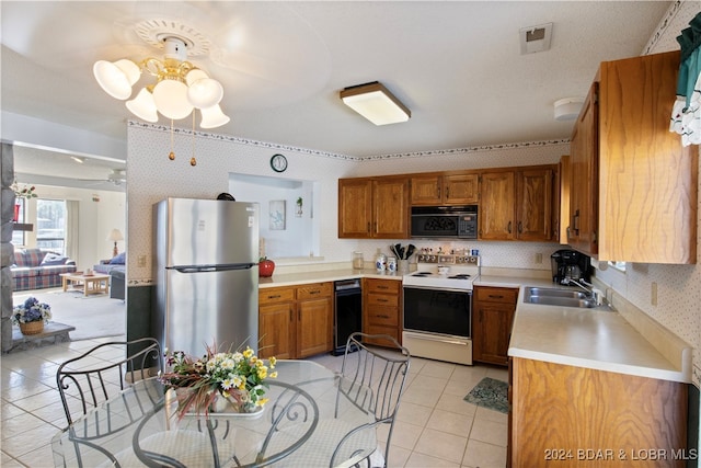 kitchen featuring ceiling fan, sink, light tile patterned floors, white range with electric cooktop, and stainless steel refrigerator