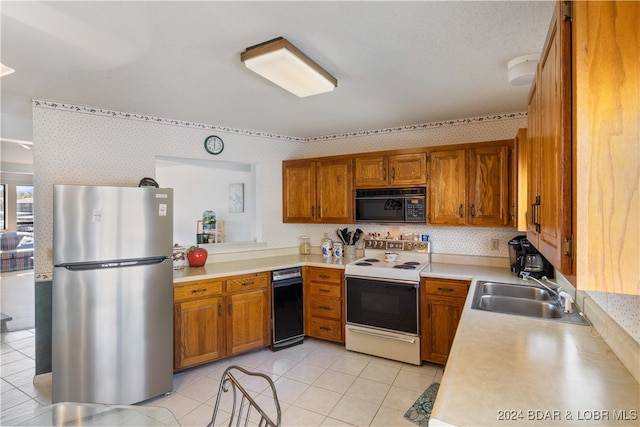 kitchen with stainless steel fridge, light tile patterned floors, white range with electric stovetop, and sink