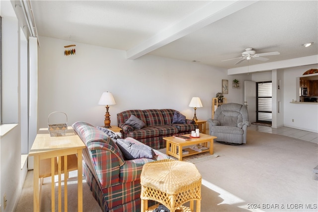 living room featuring carpet flooring, ceiling fan, and beamed ceiling