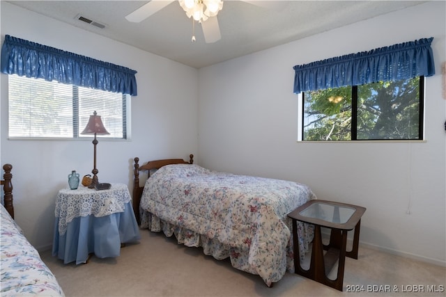 bedroom featuring ceiling fan and carpet