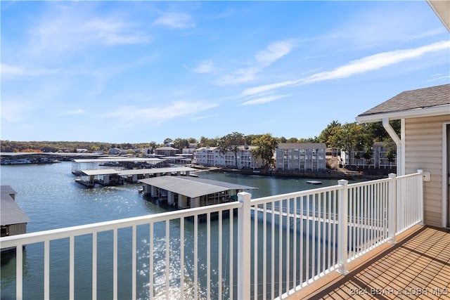 exterior space featuring a balcony and a water view