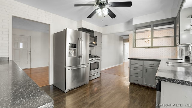 kitchen with appliances with stainless steel finishes, sink, dark hardwood / wood-style flooring, ceiling fan, and gray cabinets