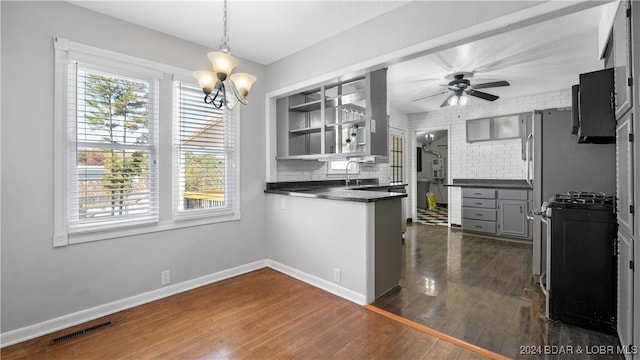 kitchen with backsplash, a wealth of natural light, and dark hardwood / wood-style floors