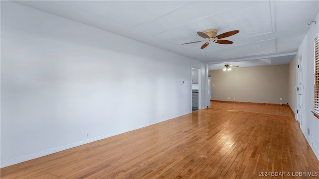 spare room with wood-type flooring and ceiling fan