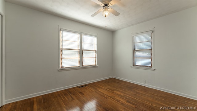 spare room with ceiling fan and dark hardwood / wood-style flooring