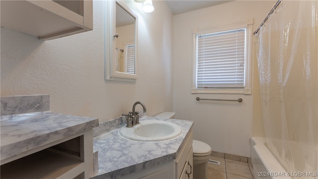 full bathroom featuring vanity, shower / bath combo with shower curtain, toilet, and tile patterned floors