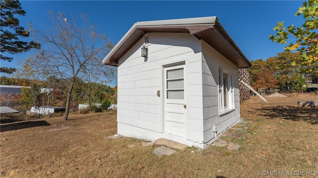 view of outdoor structure with a lawn