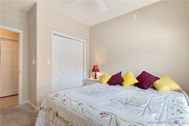 carpeted bedroom featuring a closet and ceiling fan