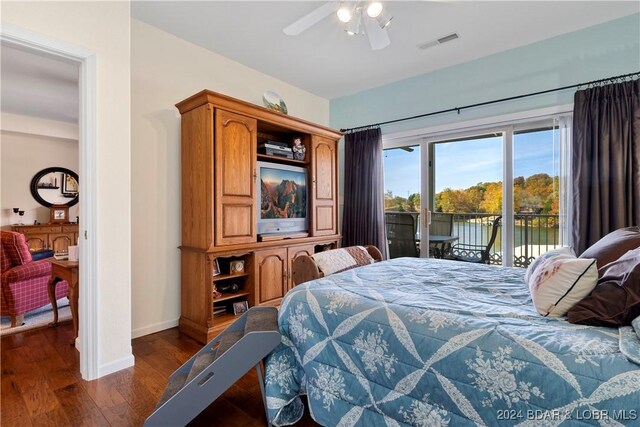 bedroom featuring ceiling fan, dark hardwood / wood-style flooring, and access to exterior