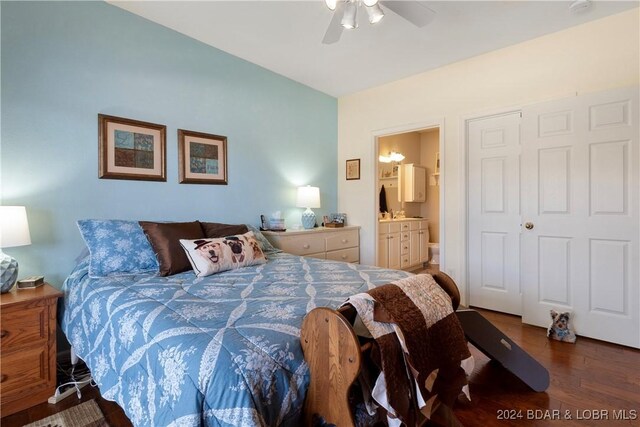 bedroom with dark wood-type flooring, ceiling fan, connected bathroom, and a closet