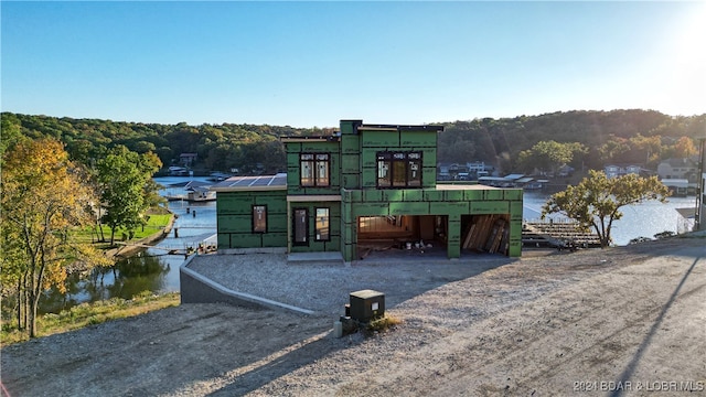 view of front facade with a water view