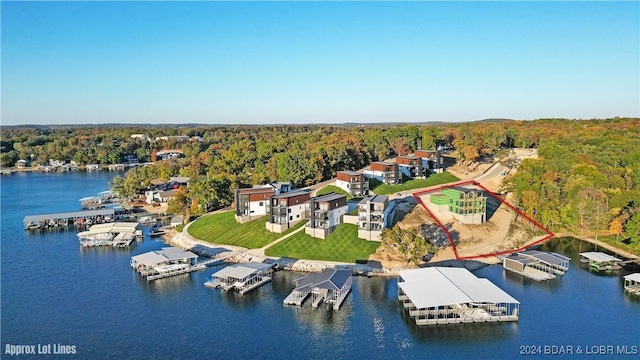6 Forest Lake Cir, Lake Ozark, MO 65049 - aerial view of property and surrounding area with a heavily wooded area, property boundaries highlighted, and a nearby body of water