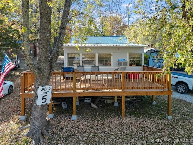 rear view of house featuring cooling unit and a deck