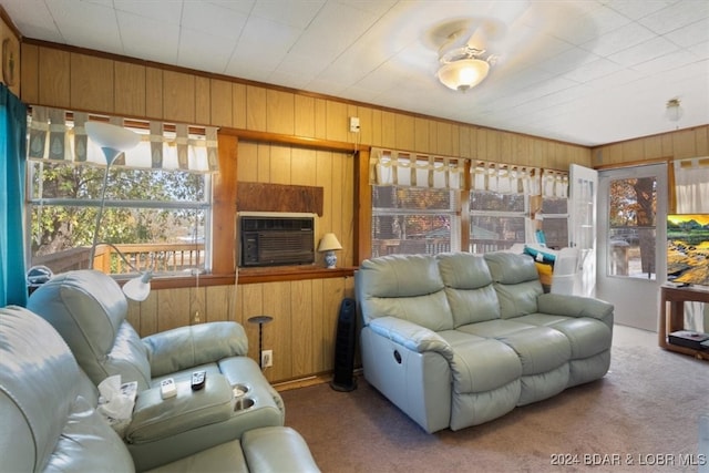 carpeted living room featuring cooling unit and wooden walls