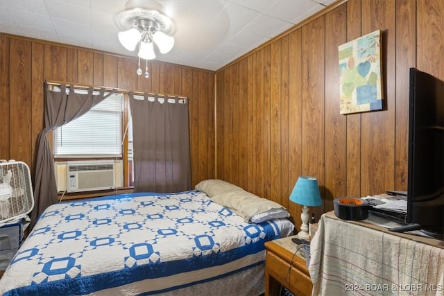 bedroom with wooden walls and ceiling fan