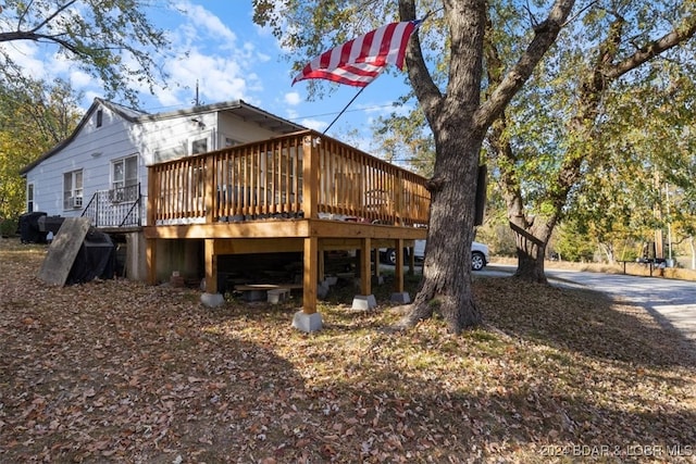 rear view of house with a wooden deck