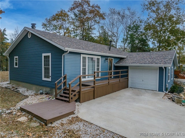 ranch-style house with a wooden deck and a garage