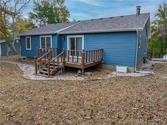 back of house with a wooden deck