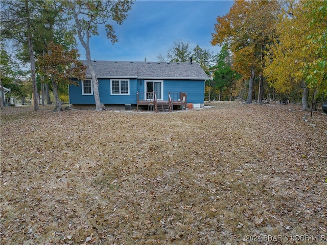 rear view of house with a wooden deck