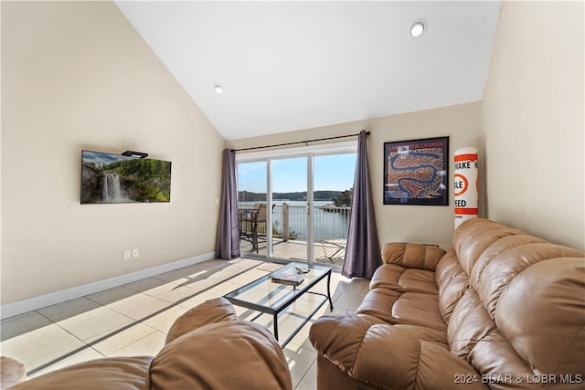 living room featuring light tile patterned flooring and high vaulted ceiling