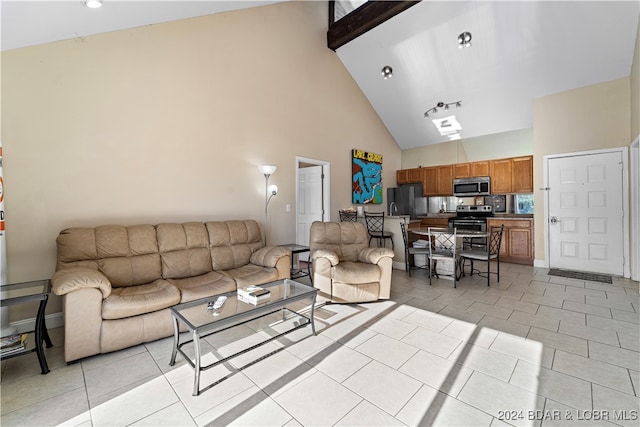 tiled living room featuring beam ceiling and high vaulted ceiling