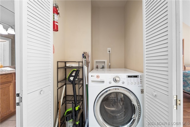 laundry area featuring washer / dryer and light hardwood / wood-style floors