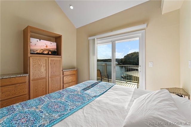 bedroom featuring access to outside, lofted ceiling, and a water view