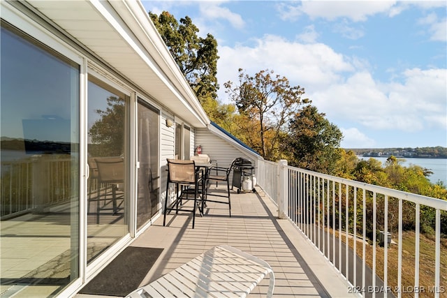 balcony featuring area for grilling and a water view