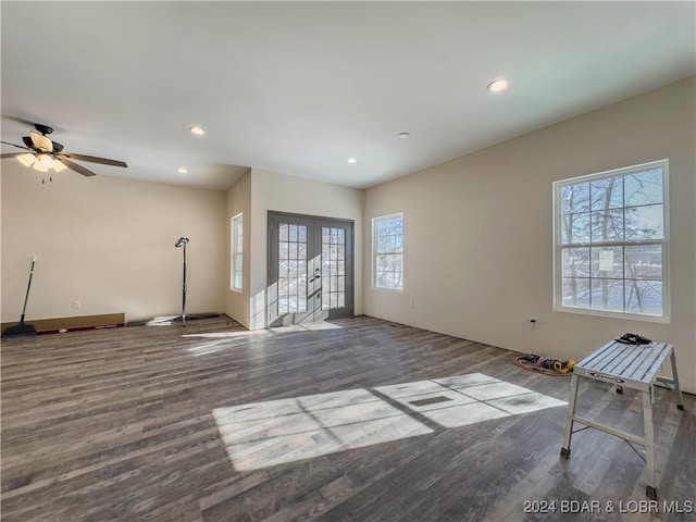 unfurnished living room with recessed lighting, wood finished floors, and french doors