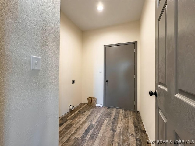 clothes washing area featuring laundry area, dark wood finished floors, and electric dryer hookup