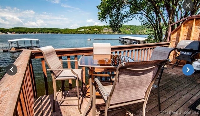 exterior space featuring a grill and a water view