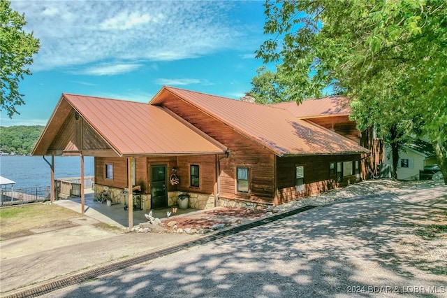 chalet / cabin with metal roof and a carport