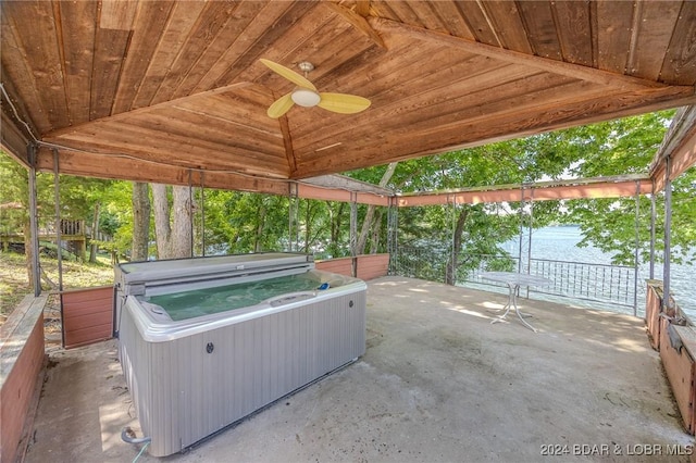 view of patio featuring ceiling fan and a hot tub