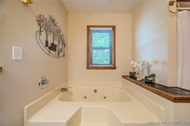 bathroom with a bathing tub and a textured ceiling