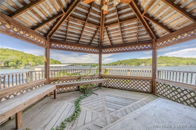 wooden terrace featuring a gazebo, ceiling fan, and a water view