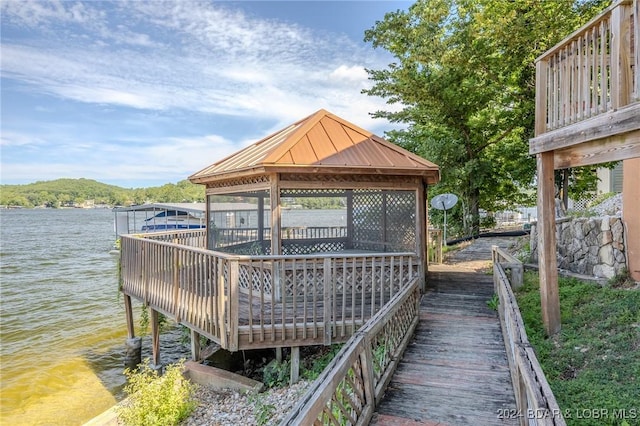 view of dock featuring a gazebo and a water view