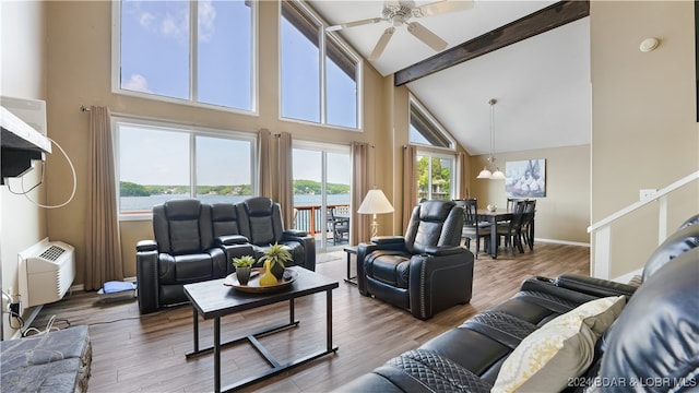 living room featuring a water view, ceiling fan, a wealth of natural light, and hardwood / wood-style floors