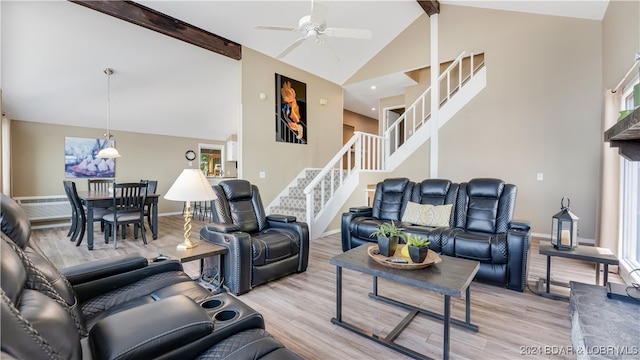 living room with light hardwood / wood-style floors, high vaulted ceiling, beam ceiling, and ceiling fan