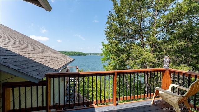 wooden terrace featuring a water view