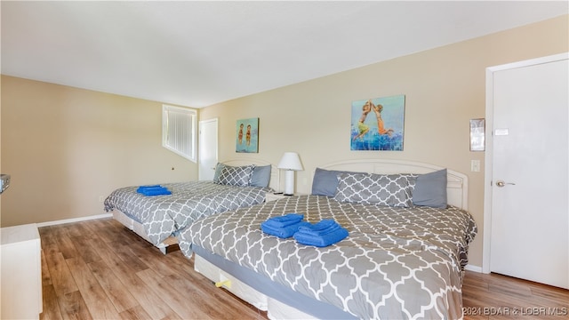 bedroom with wood-type flooring