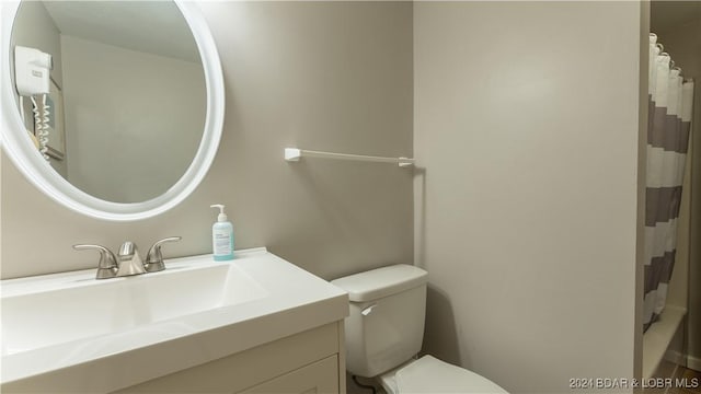 63 Elbow Cay Dr, Osage Beach, MO 65065 - bathroom with toilet, vanity, and curtained shower