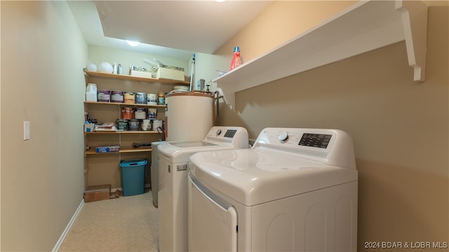 laundry room featuring light carpet, washing machine and clothes dryer, and gas water heater