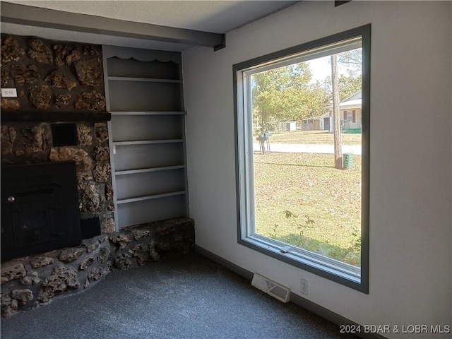 607 N Hughes Ave, Stover, MO 65078 - unfurnished living room with carpet flooring, baseboards, and built in shelves