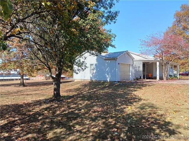607 N Hughes Ave, Stover, MO 65078 - view of property exterior featuring an attached garage and metal roof